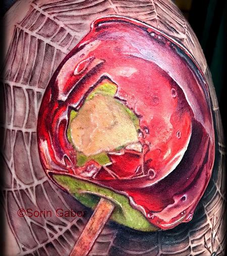 Sorin Gabor - realistic color candy apple on spiderweb tattoo 